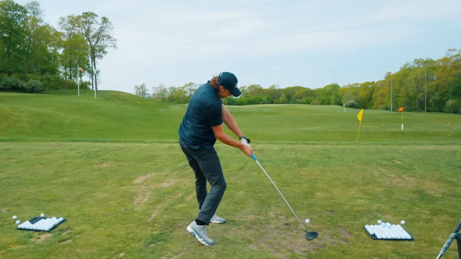 Golfer practicing slow half swings to feel draw