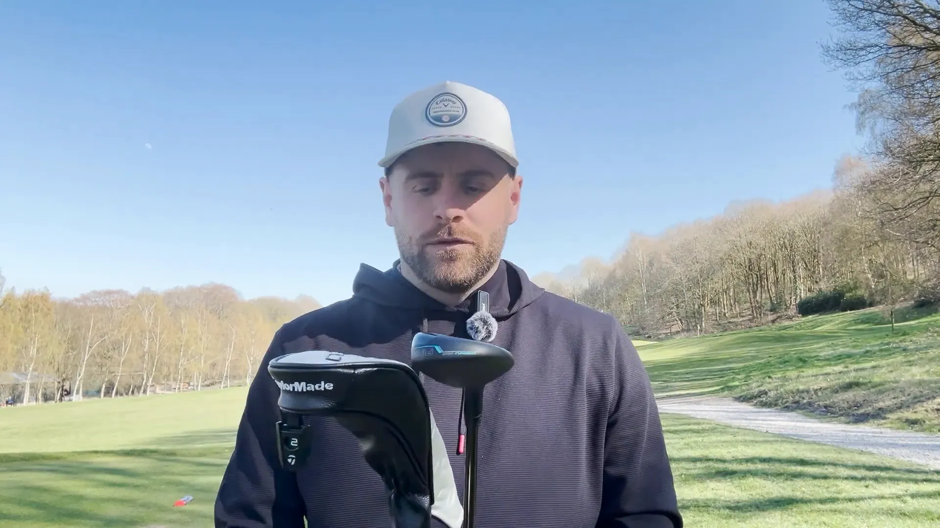 Three hybrids lined up at the tee box: Callaway AI Smoke, TaylorMade QI35, Ping G440