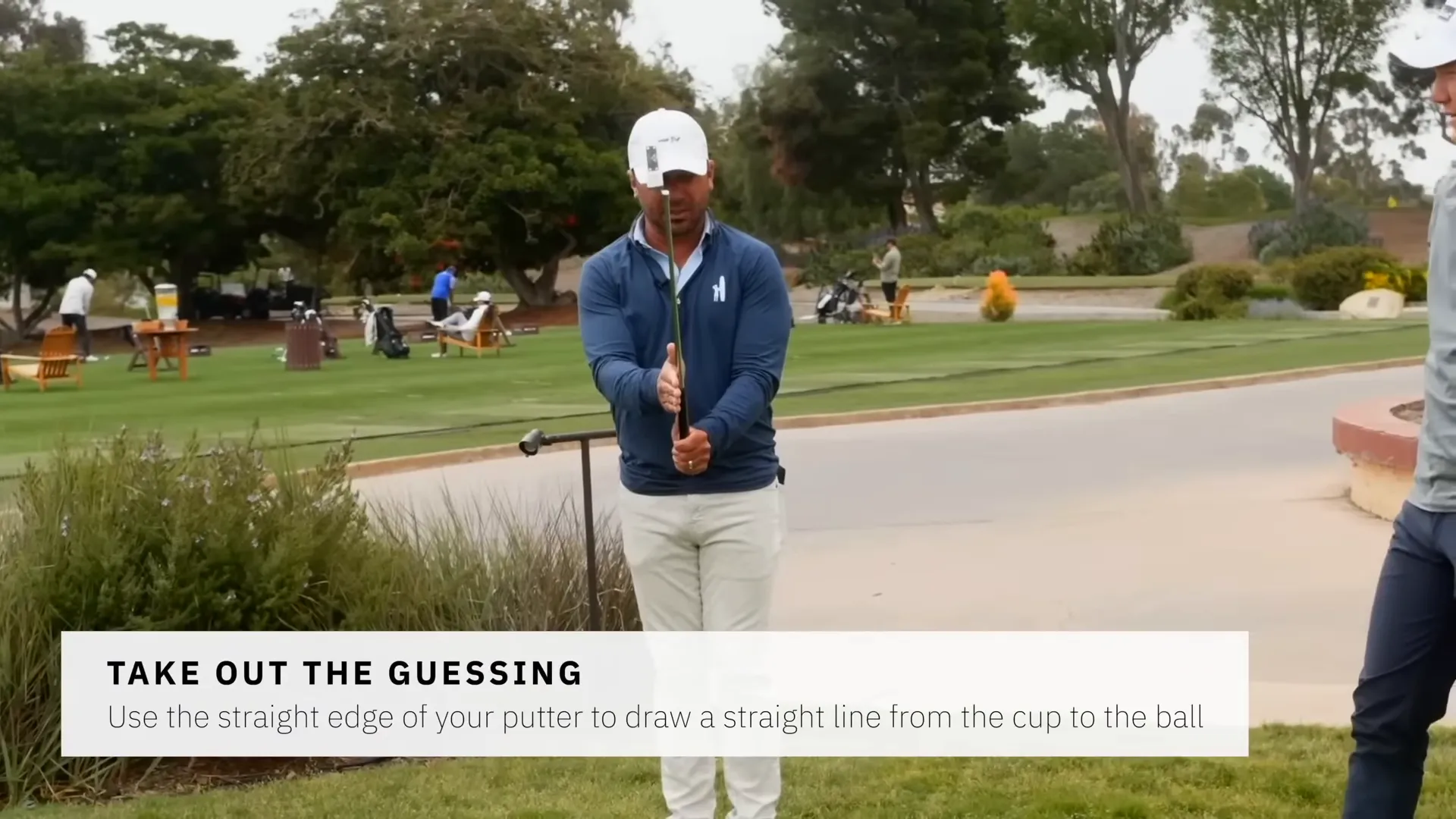 Player backing up, holding the putter and closing one eye to pick the correct line