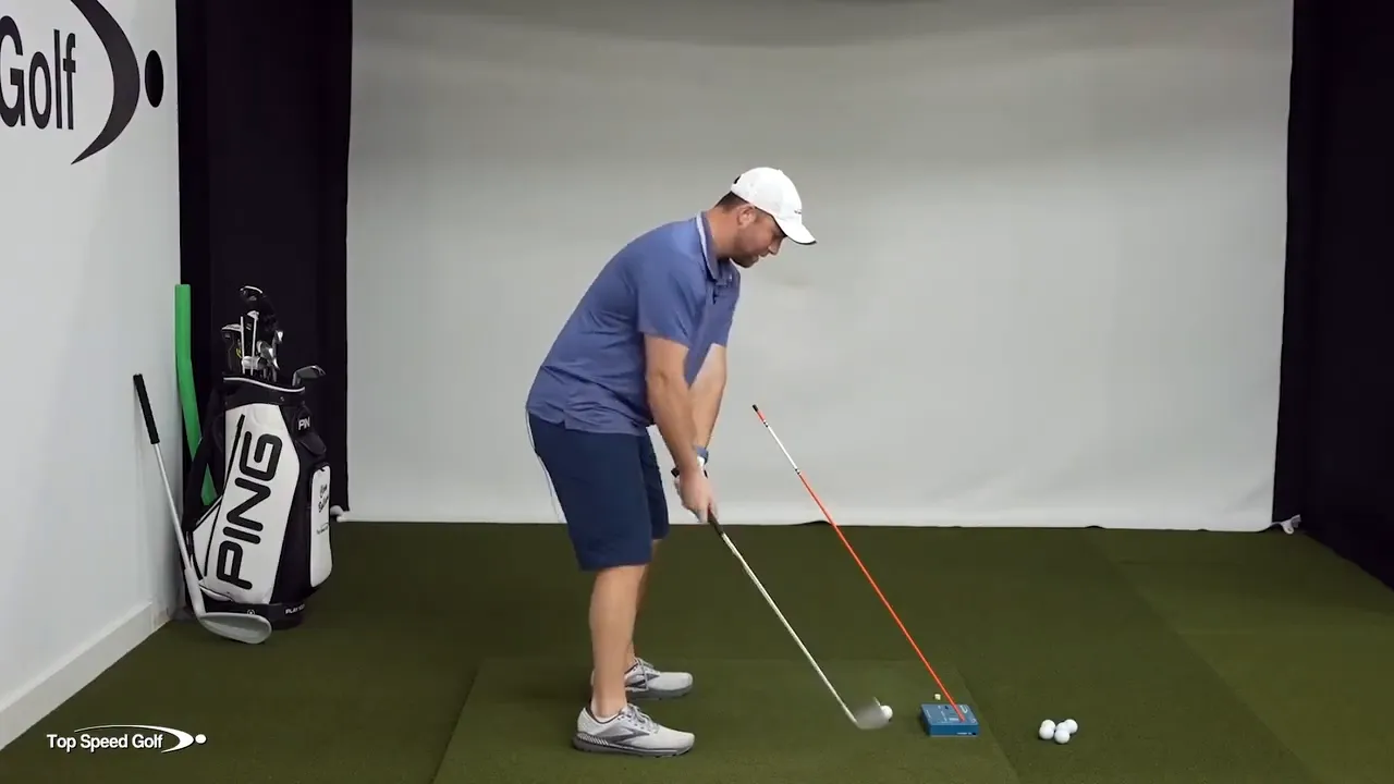 Demonstrating forward hand position and shaft lean at impact