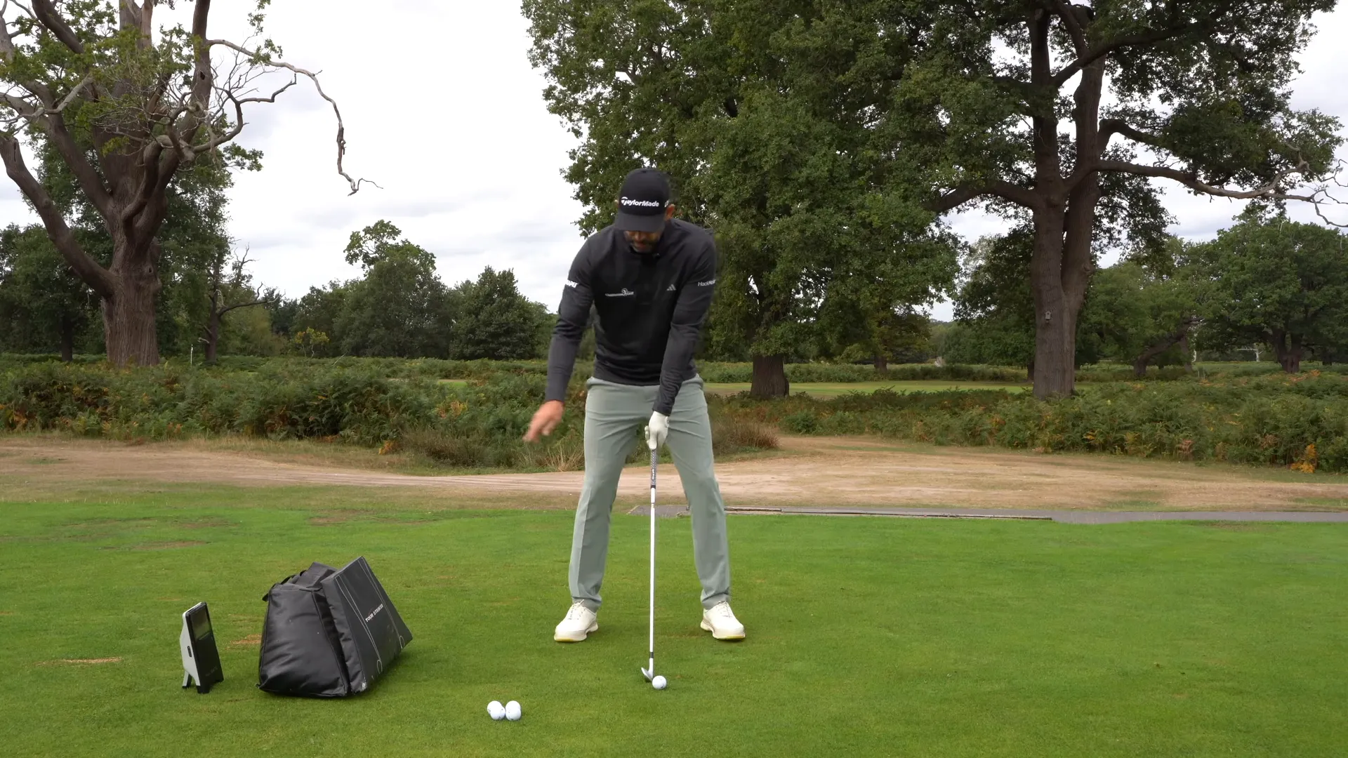 golfer setting up an impact bag near the ball to check swing width