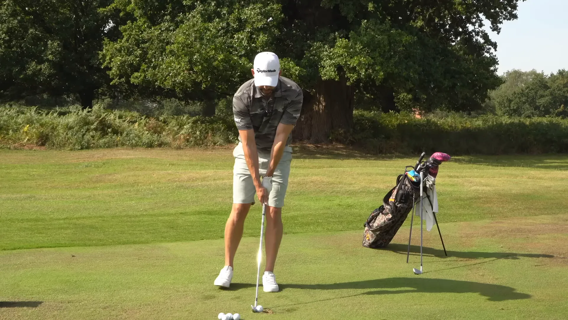 Performing a backswing step drill with a seven iron to initiate body-first movement