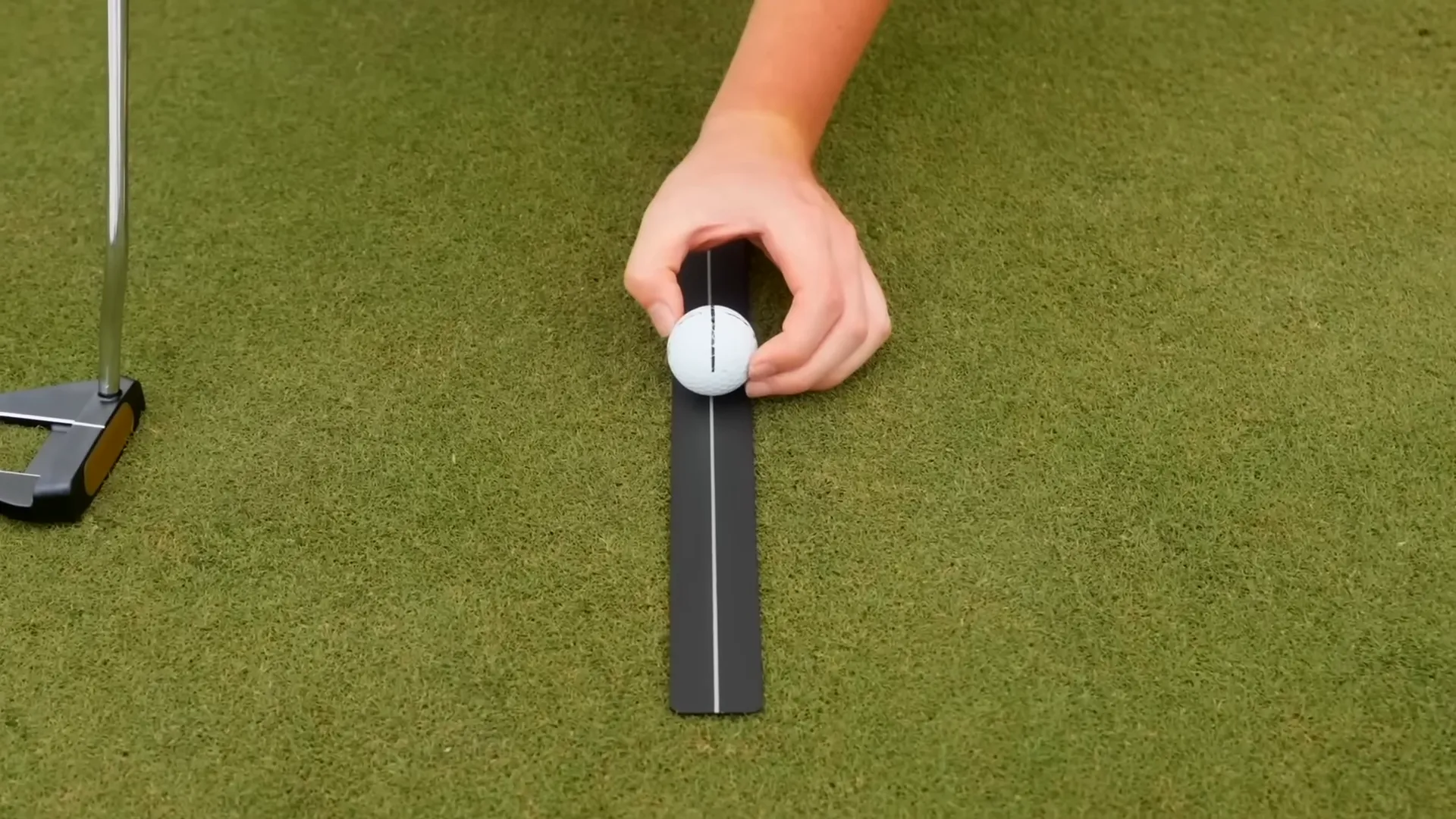 Player practicing with a training aid for alignment and stroke length