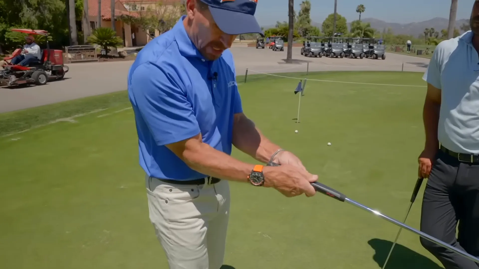Hands rotated in, elbows bent and tucked into the chest corner at setup