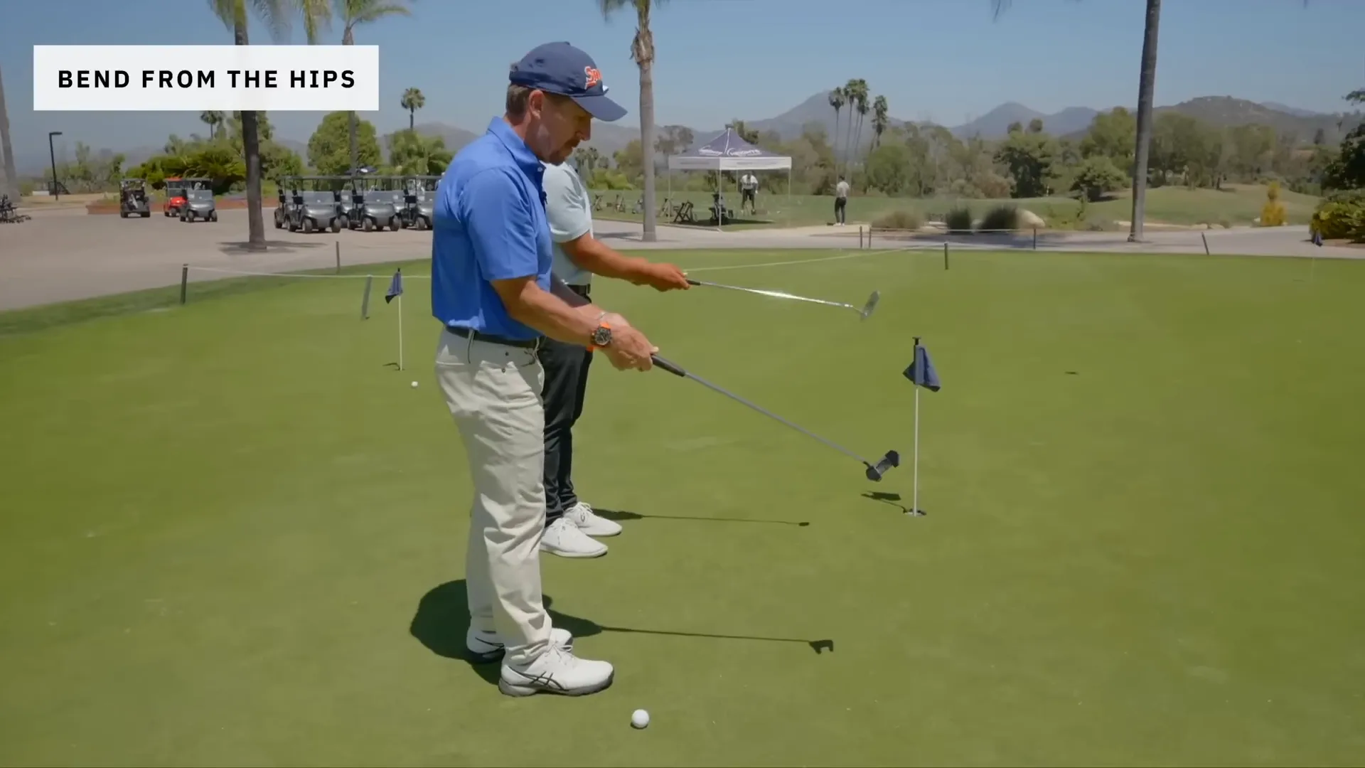 Tilt from the hips and maintain connection as putter reaches the ground