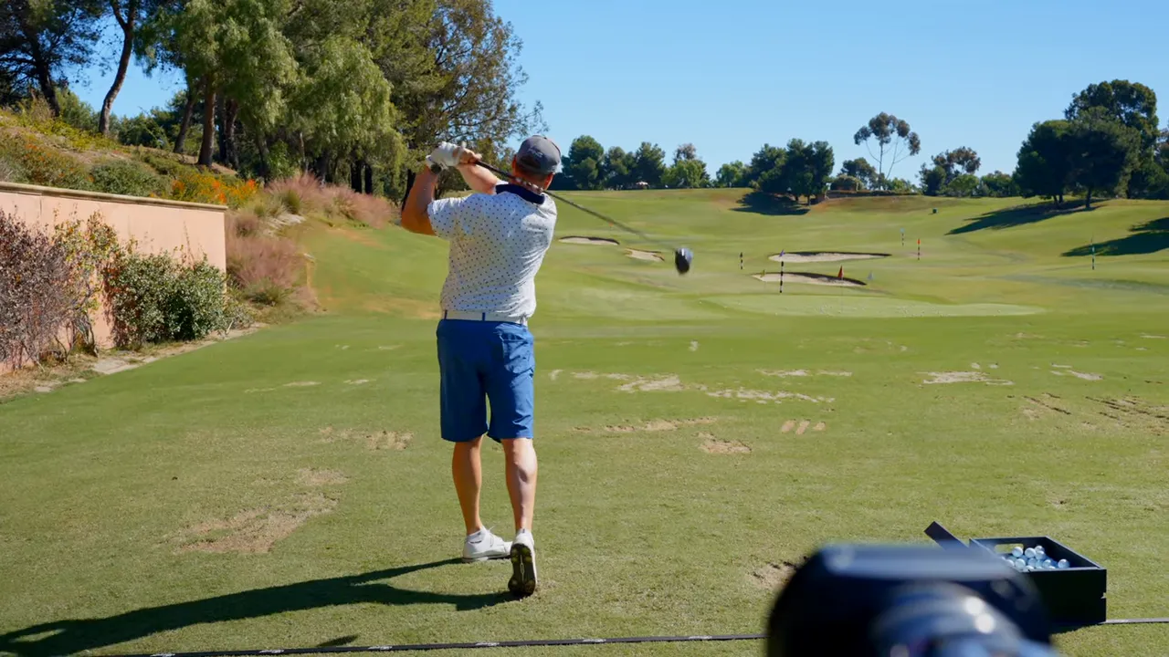 Player hits a perfectly struck driver shot; instructor calls it piped