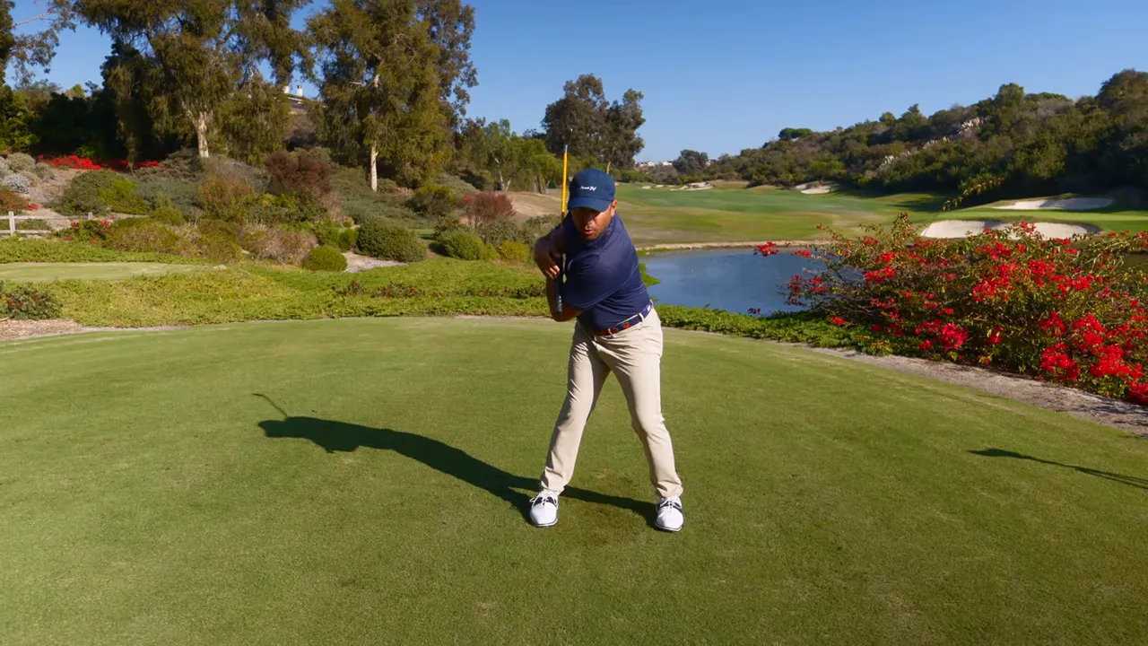 Instructor demonstrating the merry-go-round drill with the club across the chest