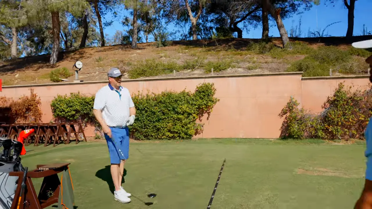 Instructor discussing rhythm importance with player holding long driver