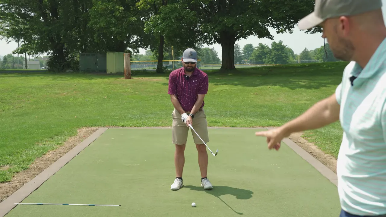 Instructor pointing out body rotation and shoes turning to emphasize full hip rotation
