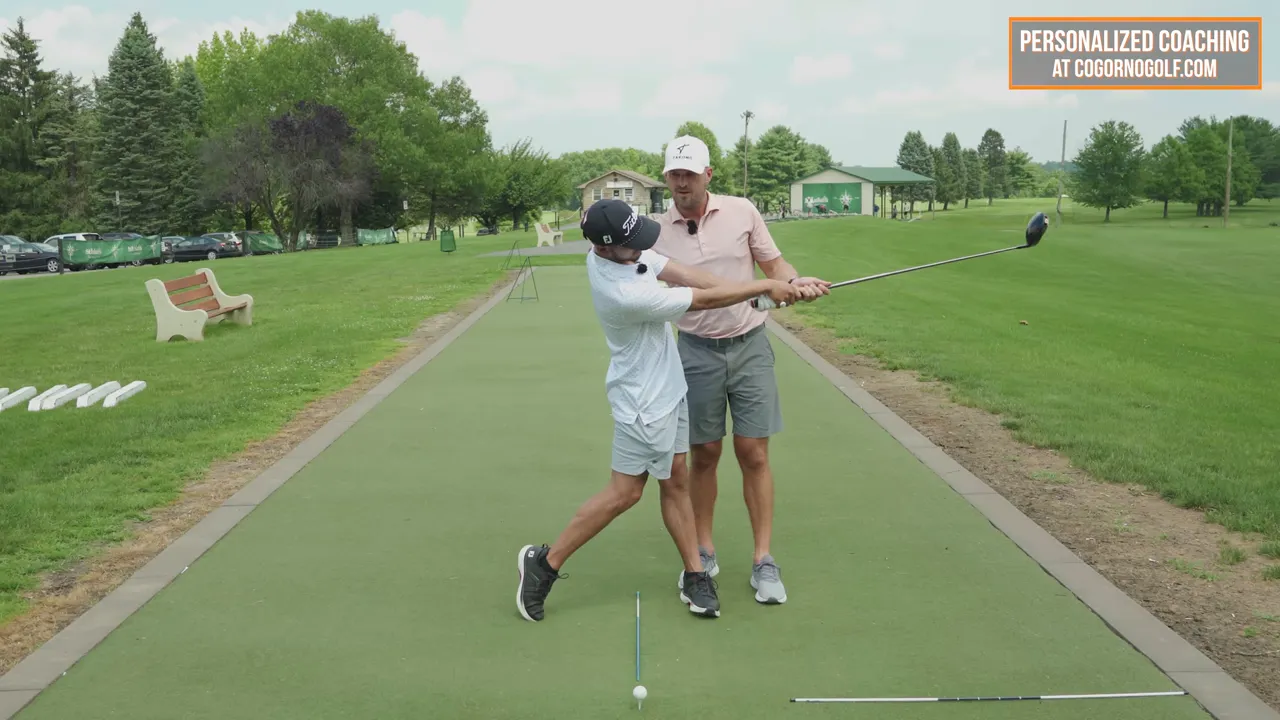 Coach guiding a student through the push-away drill with the club extended