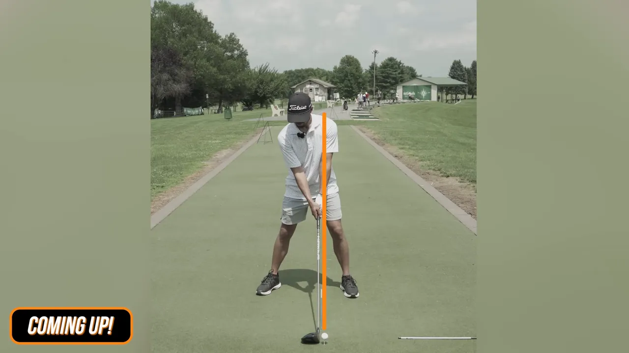 Front-on view of neutral driver setup showing hands slightly forward, shaft vertical, and ball under lead armpit