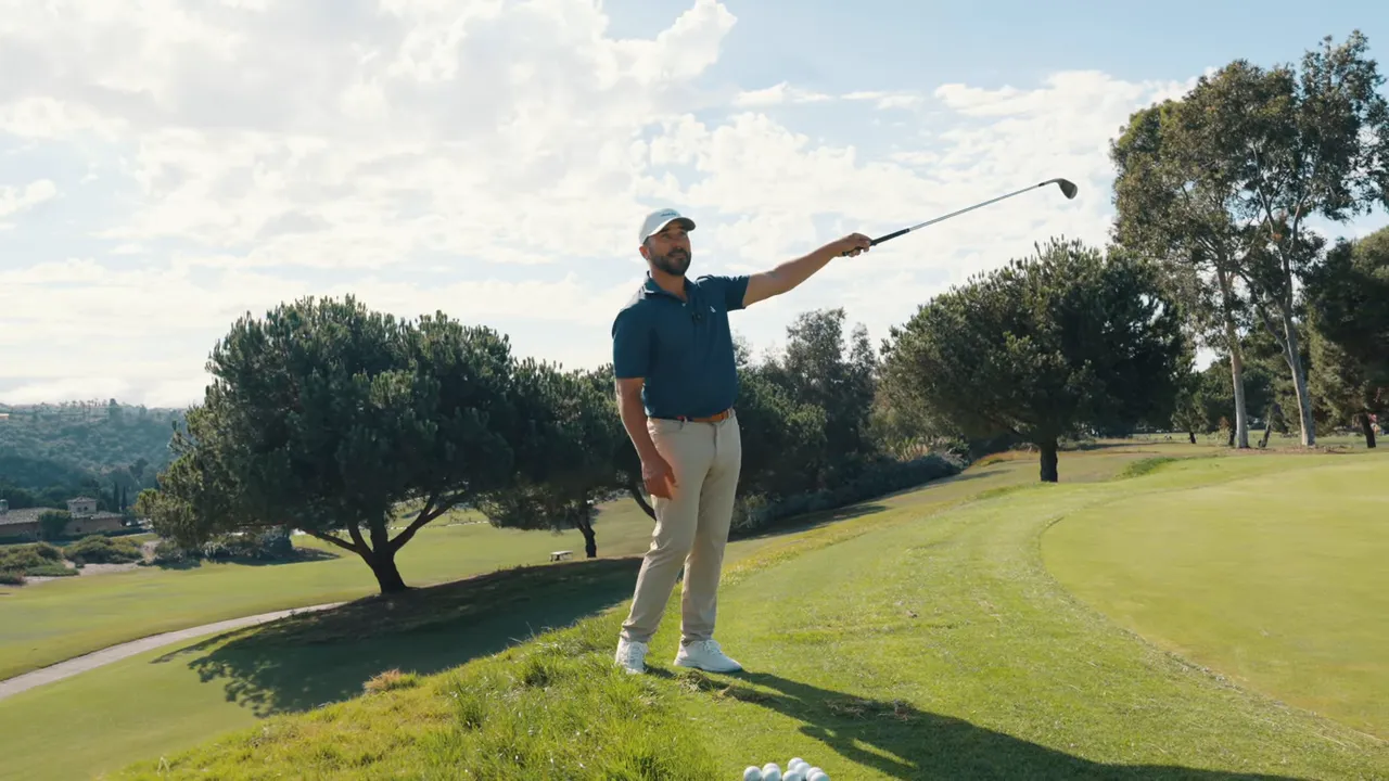Player following through after a controlled shot from deep rough