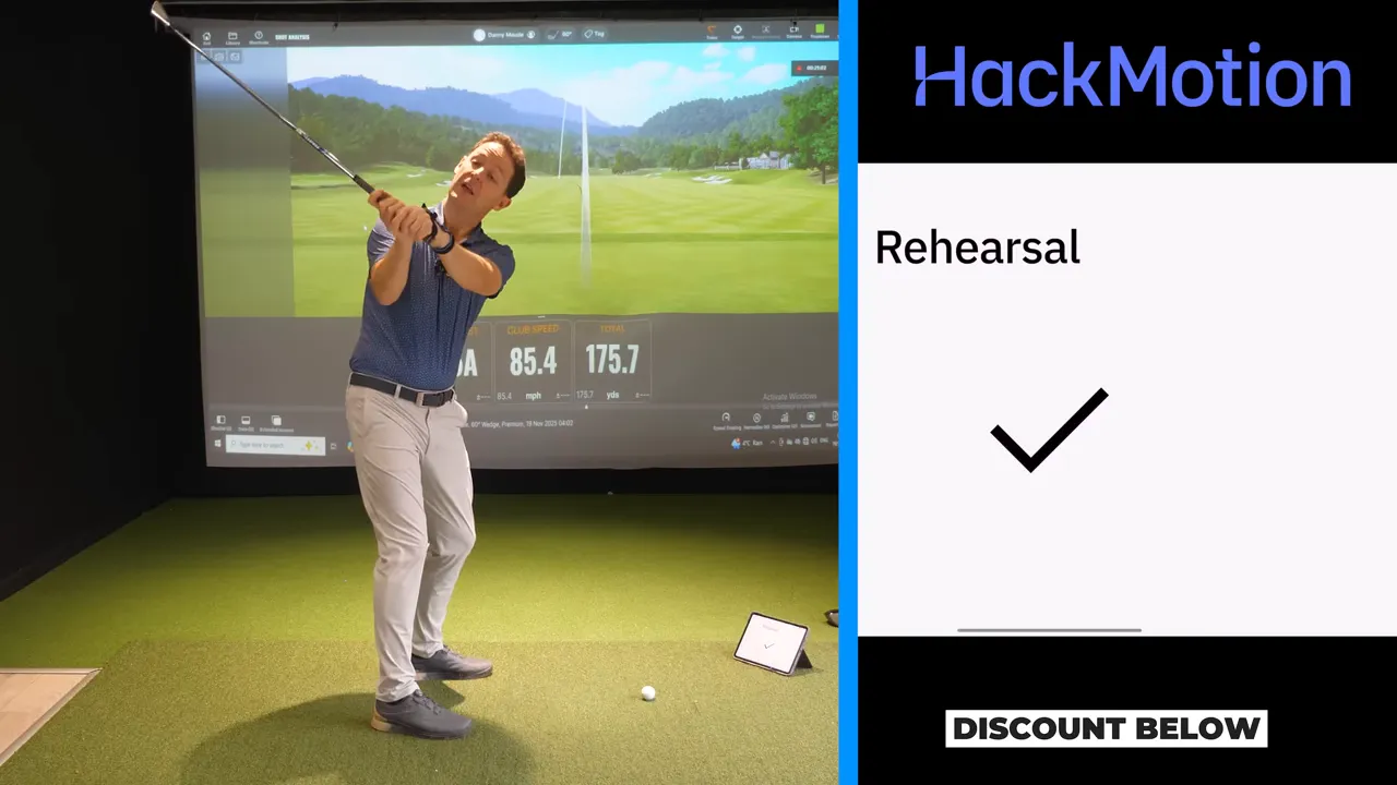 Golfer paused at the top of the backswing with the HackMotion app showing 'Rehearsal' and a check mark.