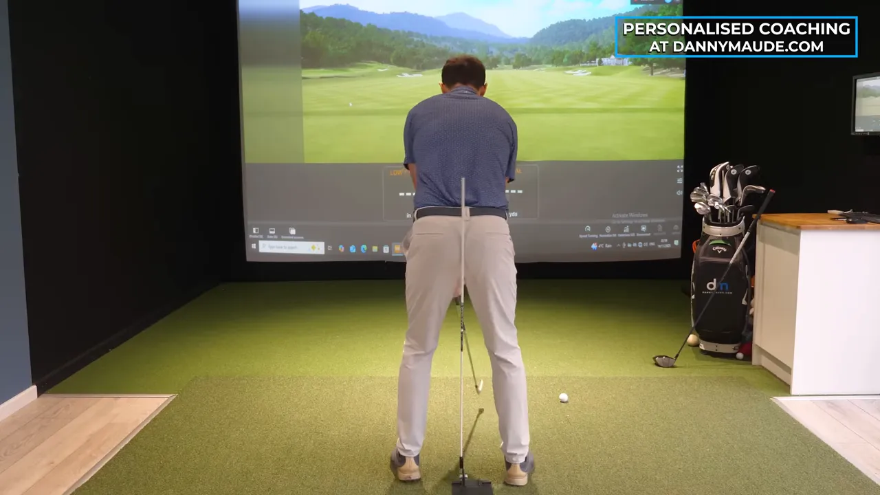 Back view of golfer with vertical alignment stick placed behind the hips demonstrating pelvis position