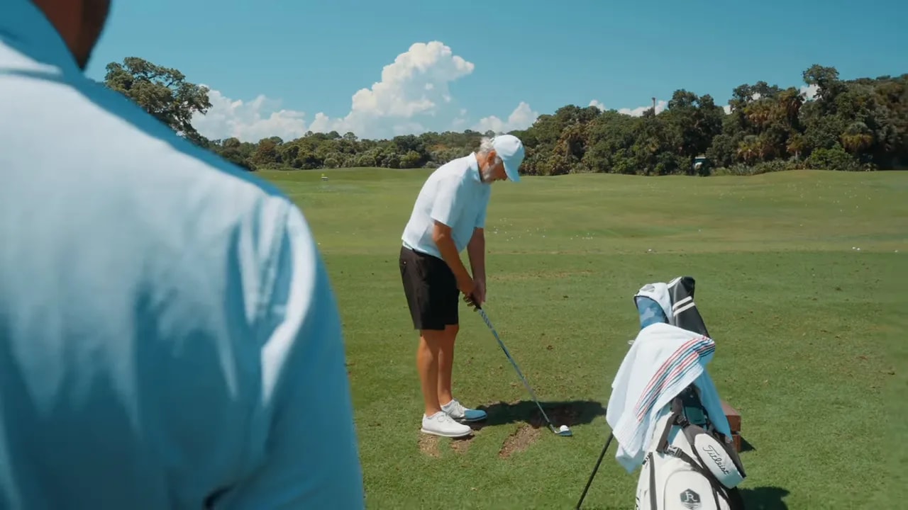 golfer at address with correct spine tilt and club behind the ball at the driving range