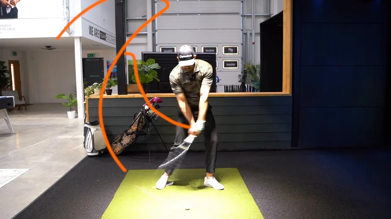 Golfer mid‑swing with an overlaid arc highlighting the clubhead lagging behind the hands