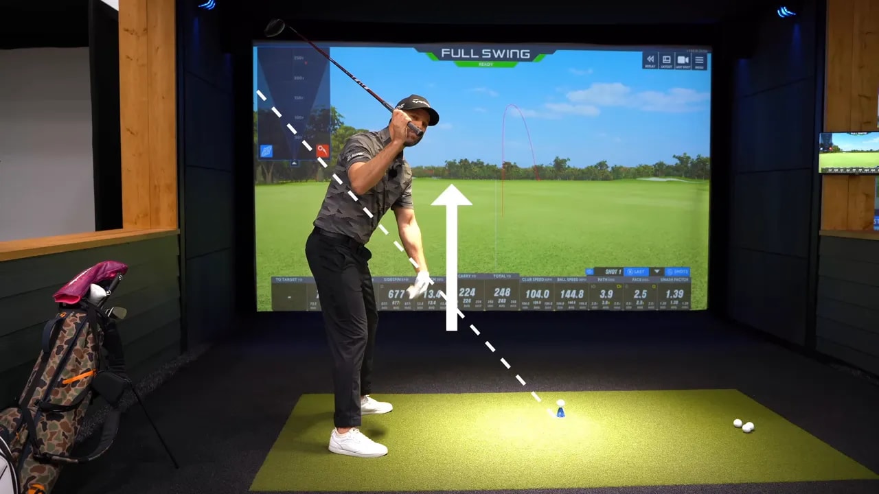 Annotated golf backswing showing dashed reference line and upward arrow illustrating grip-above-heels cue