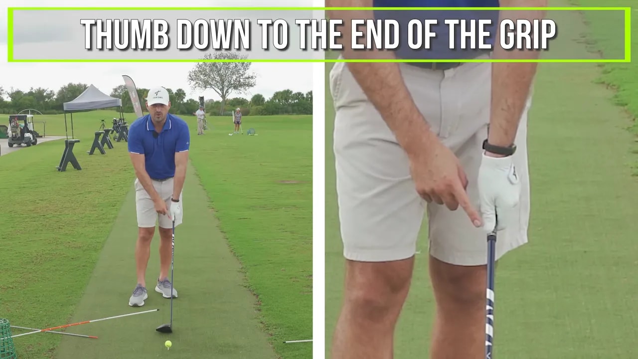 Close-up of instructor pointing to the glove/logo and thumb position on the lead hand while holding a driver, showing the recommended thumb-down grip.