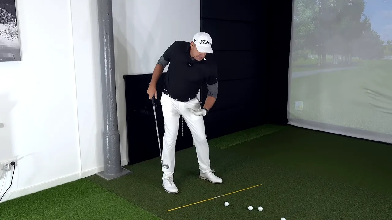 Golf coach demonstrating left thigh tucked in under the body to show left-under movement