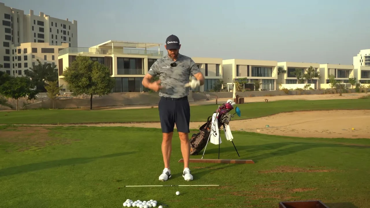 Instructor mid-demonstration showing upward chest movement and body extension over the ball