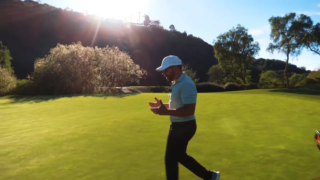 Instructor walking across the green gesturing about landing zone and spin