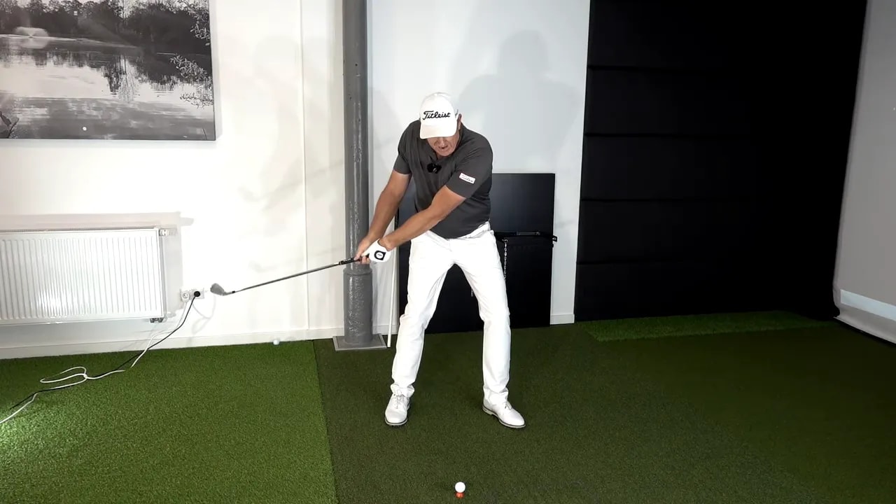 Indoor golf swing practice frame with forward swing position and ball marker to improve compression timing