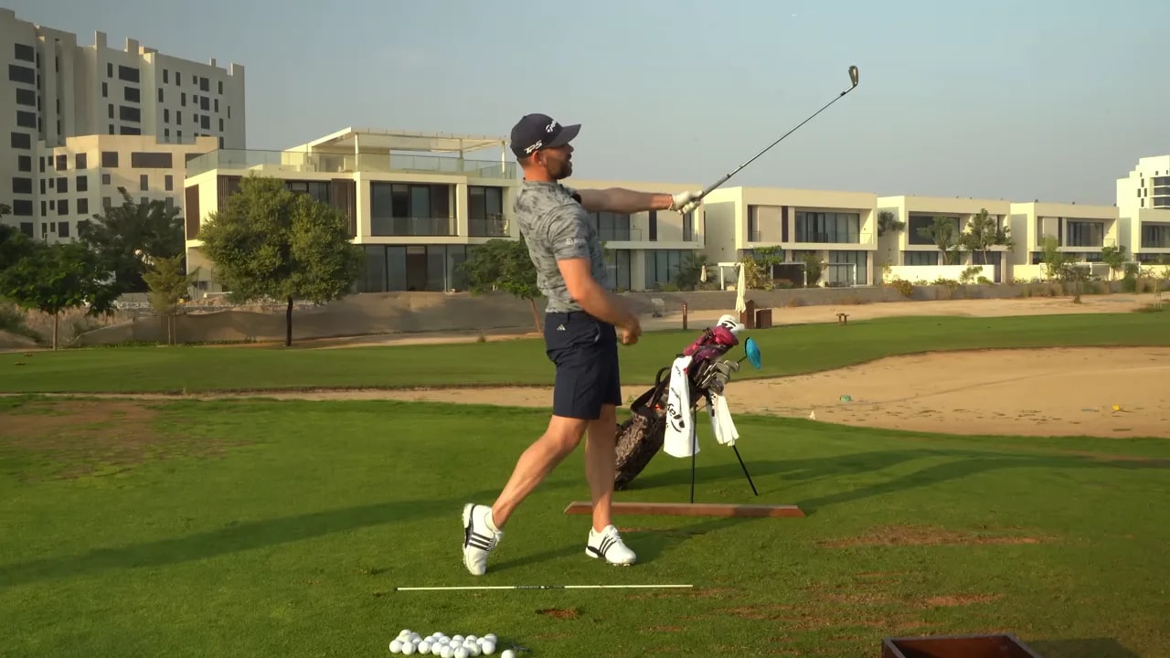 Golfer in follow-through with chest up, weight shifted and club pointing toward target