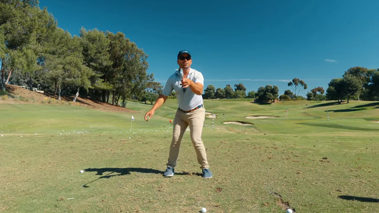 Golf instructor demonstrating disassociation cue to prevent spinning-out