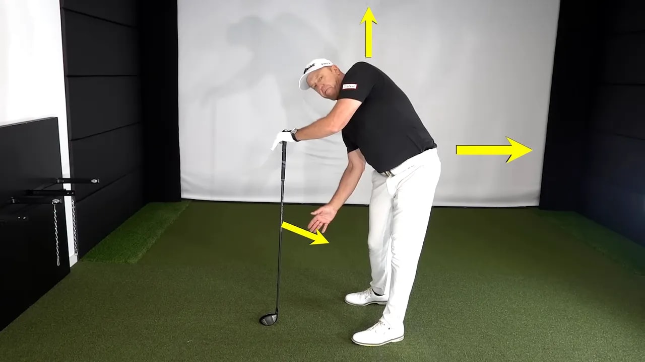 Annotated photo of the hand-on-top driver drill showing left-pocket movement and hip direction with arrows.