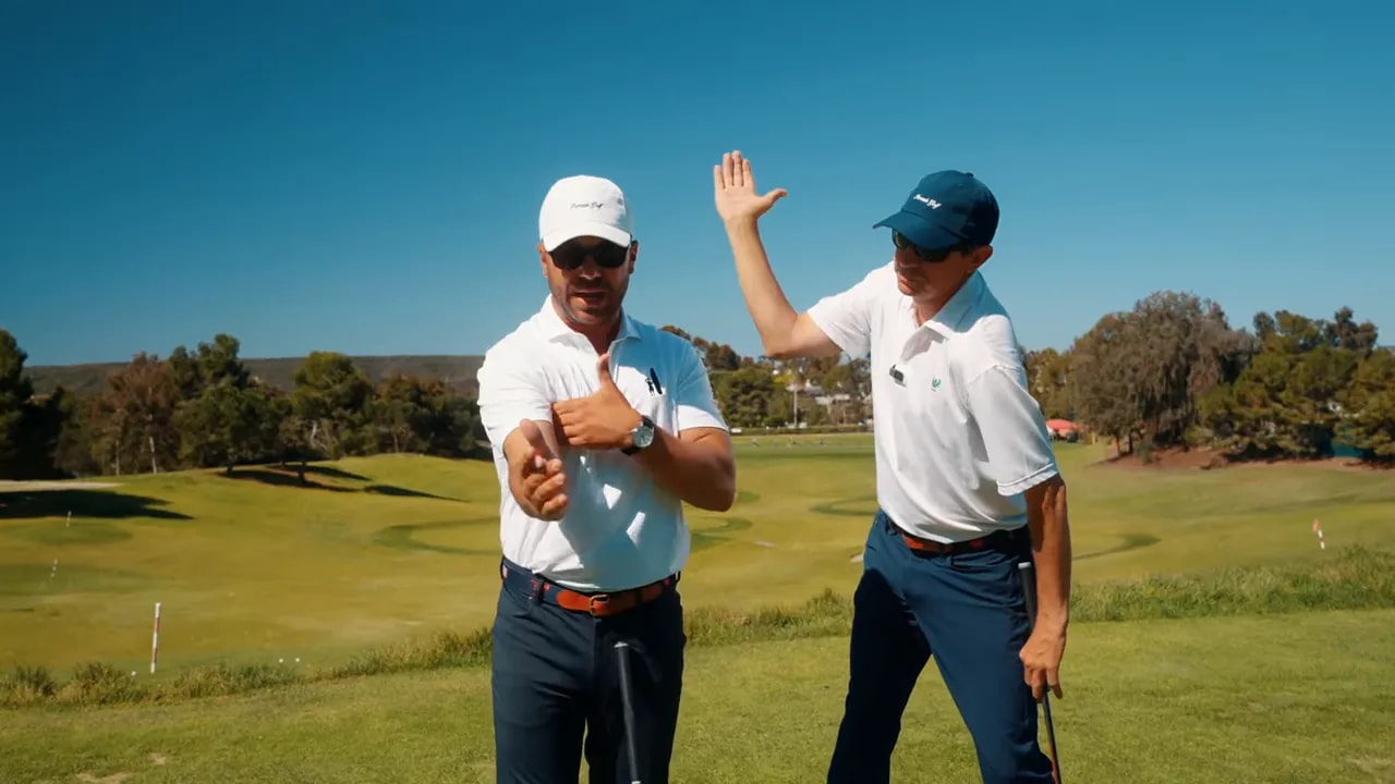 Two instructors showing hands positioned in front of the chest with a small gap between the trail elbow and torso to illustrate connection and width