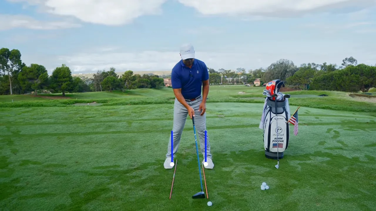 Golfer demonstrating hip bump checkpoint position with alignment rods on the fairway
