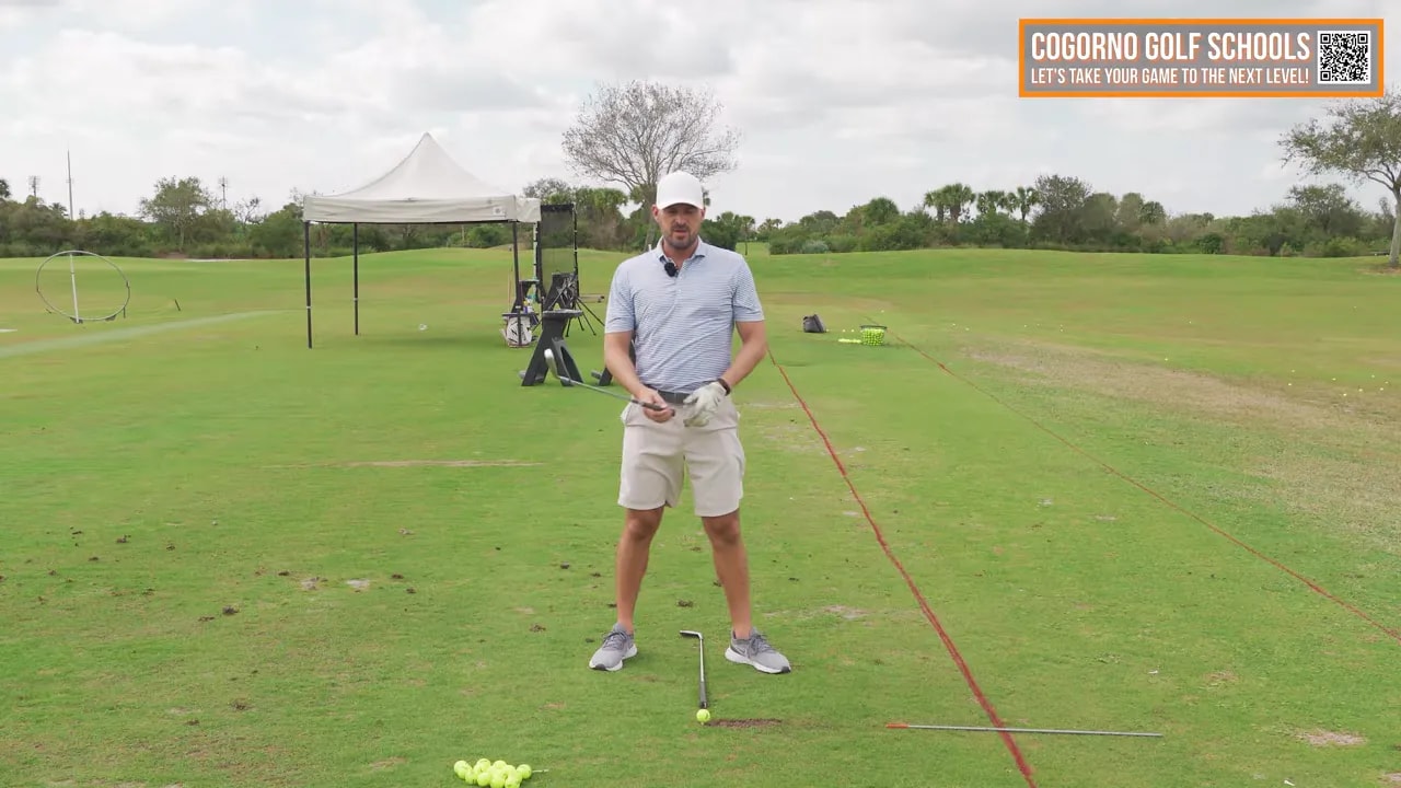 Golfer at address and impact line setup showing where hips should move forward toward the target