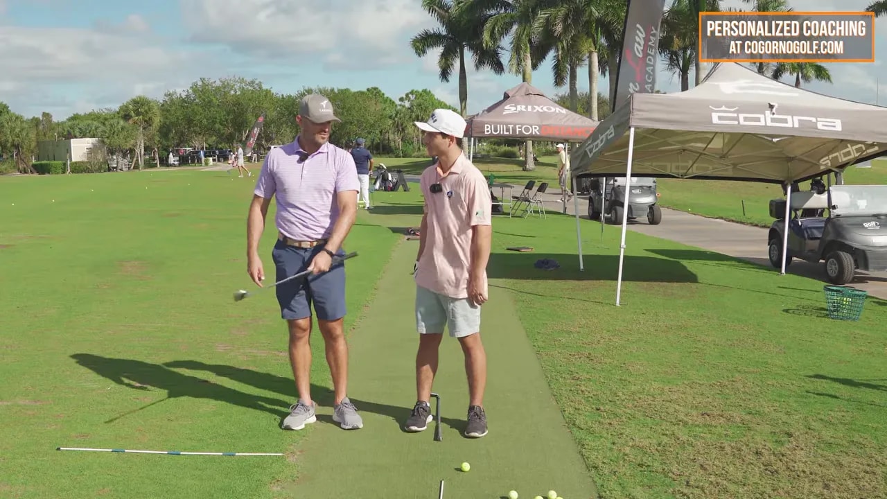 Instructor coaching a golfer at address on a practice range for the punch and twist move