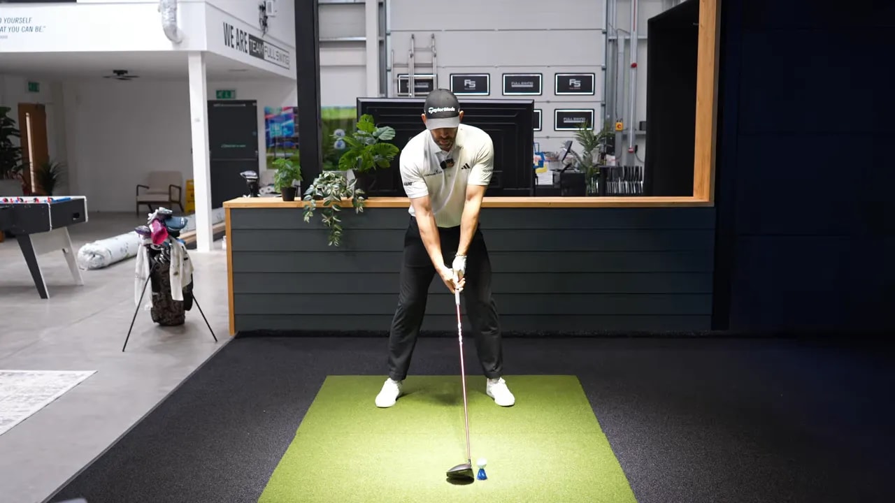 Coach setting the John Ramm style starting position with driver and ball on indoor mat