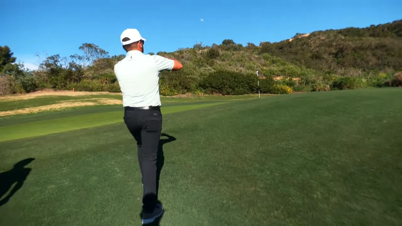 player walking toward the green with the flagstick located on the back-right shelf showing the landing zone