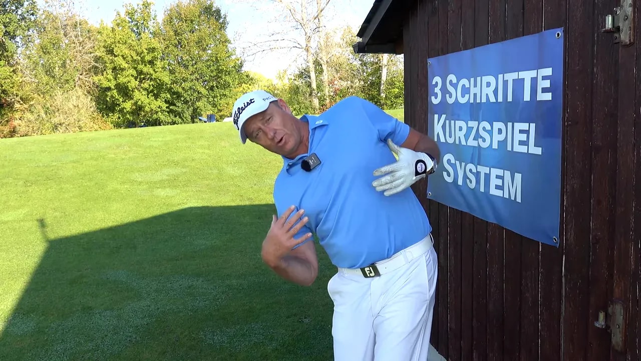 Instructor demonstrating the 'looking out the window' neck tilt with chest rotated to the lead side and hand pointing at the pec