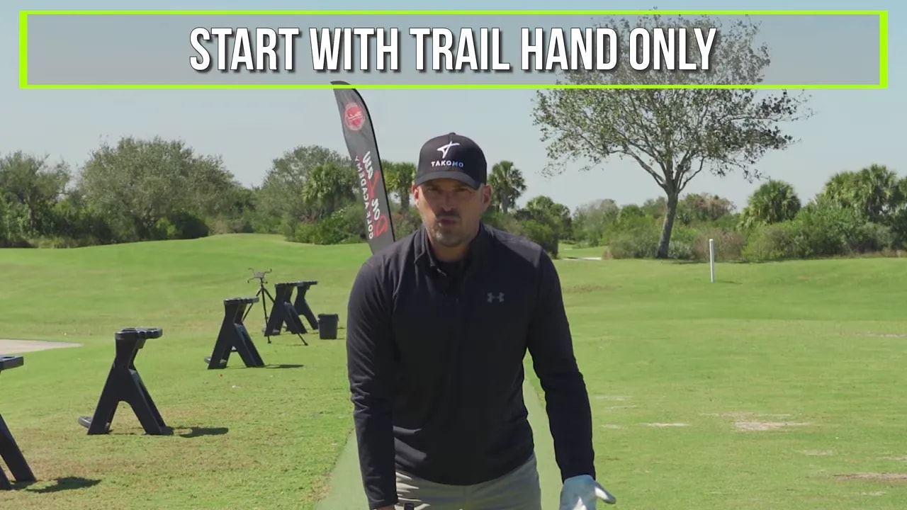 Instructor cueing 'Start with trail hand only' for the effortless power golf swing shaft drill