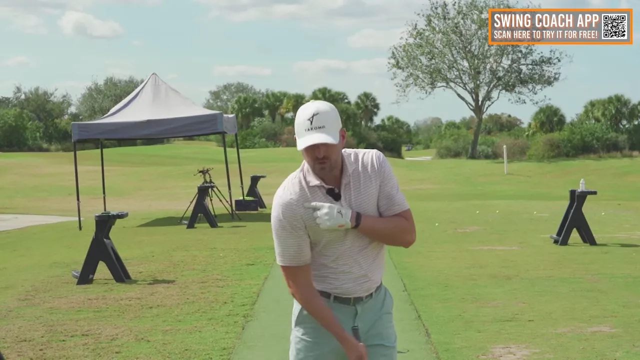 Coach pointing to the trail shoulder to demonstrate moving the shoulder forward and under the chin during the punch.