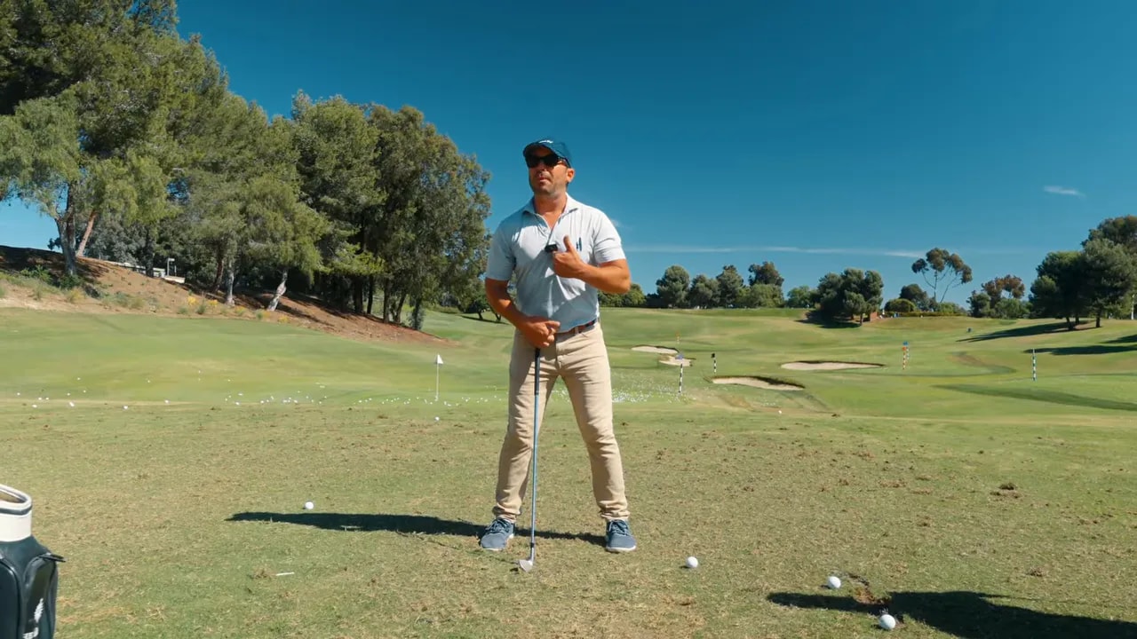 Golf coach explaining upper and lower body separation on the range