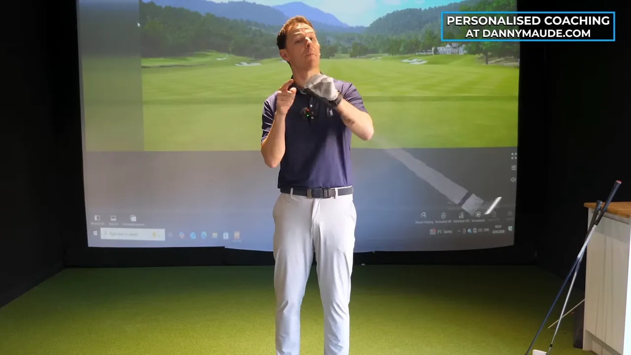 Golf coach demonstrating upward club butt-end momentum for senior golfers
