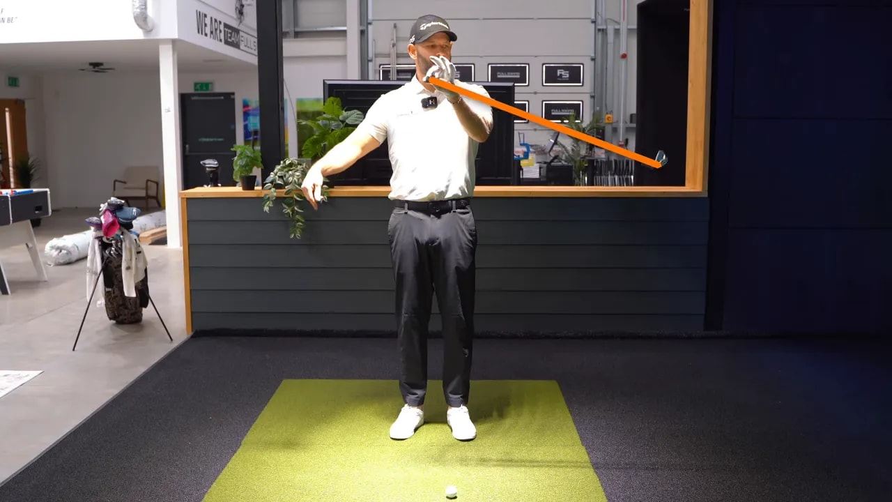 Golf instructor illustration with an orange line showing increased club travel when pulling the grip up