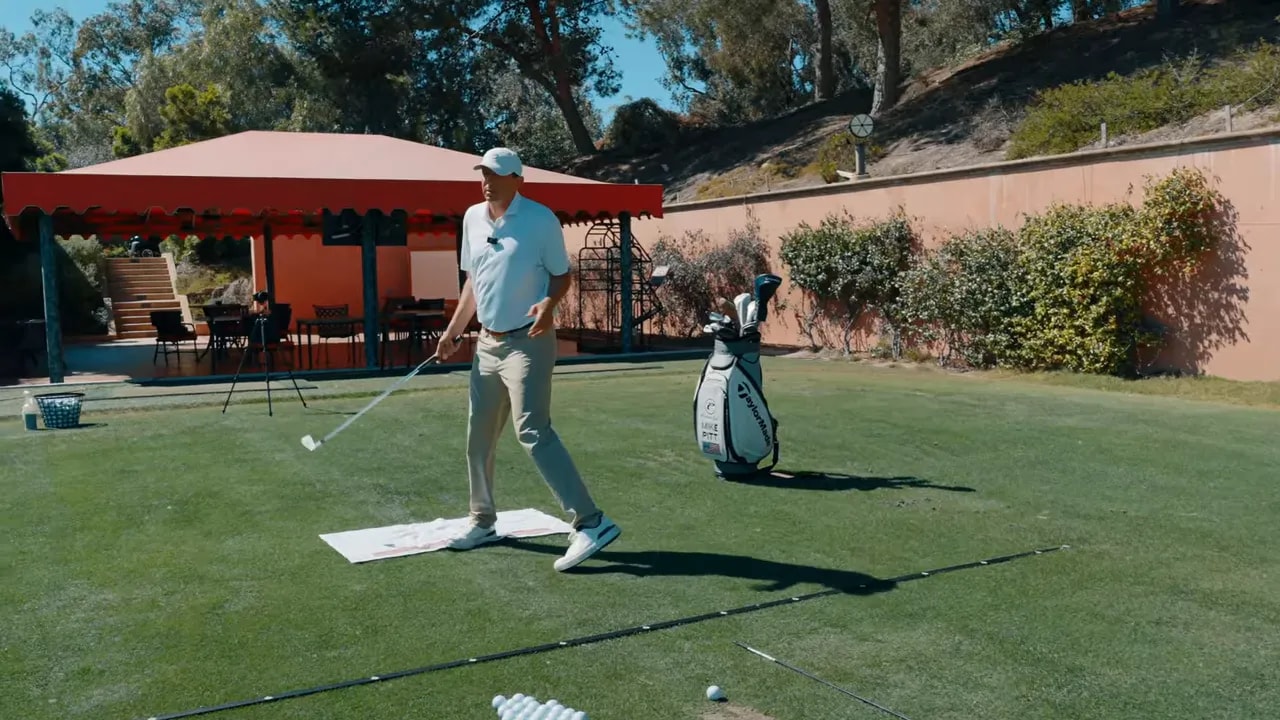 Golf instructor walking into position with feet and tempo set as part of a repeatable pre-shot routine