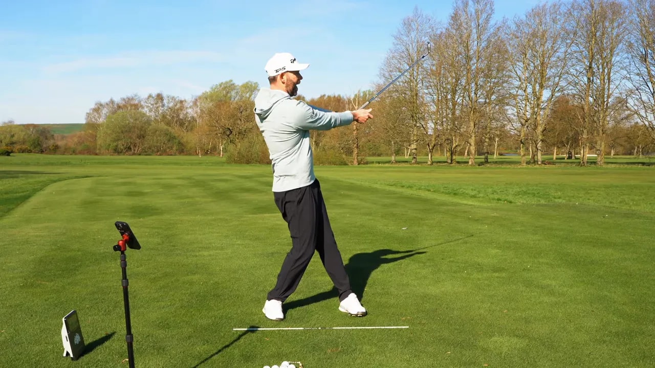 Golfer demonstrating a repeatable follow-through finish position from the 9-to-3 drill