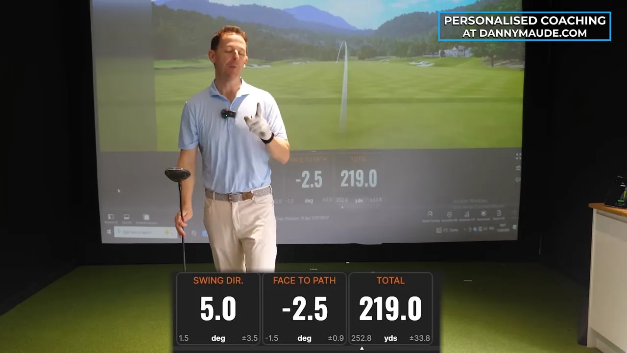 Golf coach explaining swing direction and face-to-path results on the screen