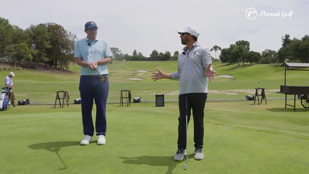 Instructor demonstrates connected setup for putting yips on a sunny practice green