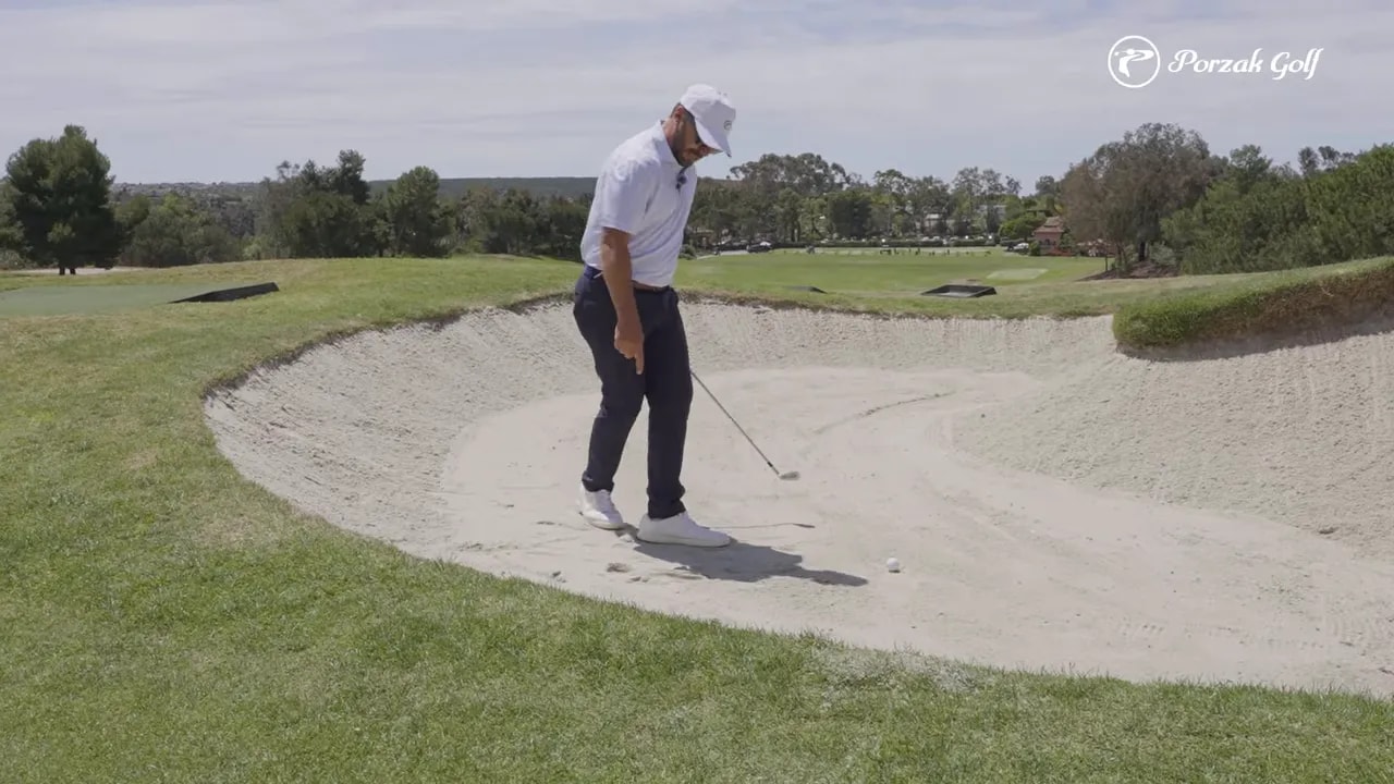 Golfer in a fairway bunker shot stance showing balanced footing and centered balance