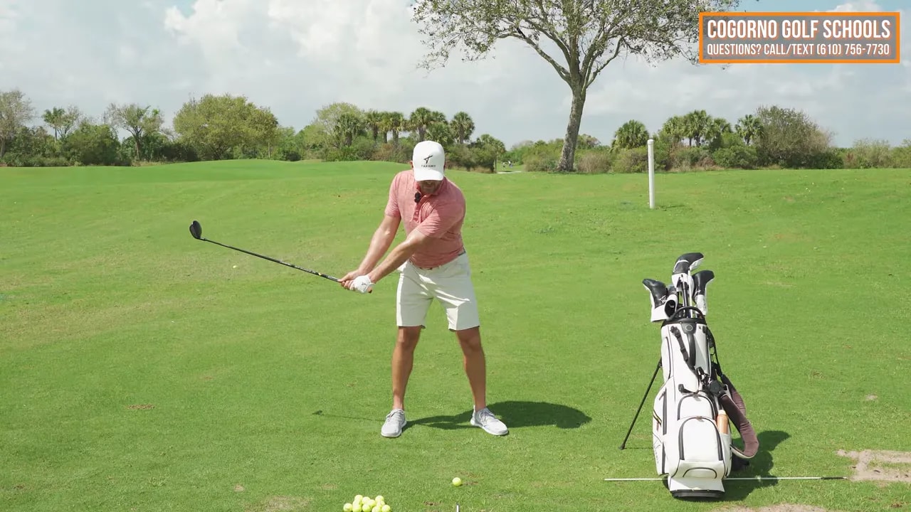 Golfer demonstrating fairway wood bag drill half-swing for outward clubhead extension