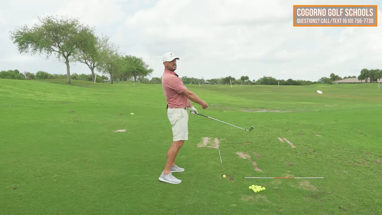 Golfer through impact maintaining posture while rotating chest out toward the target
