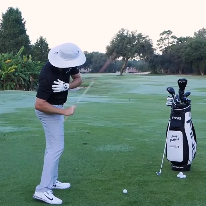 Golfer checking trail shoulder position during the downswing on a golf range