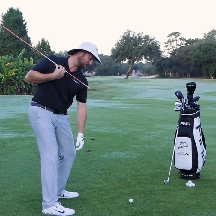 Golfer demonstrating trail shoulder position in the downswing on a practice range